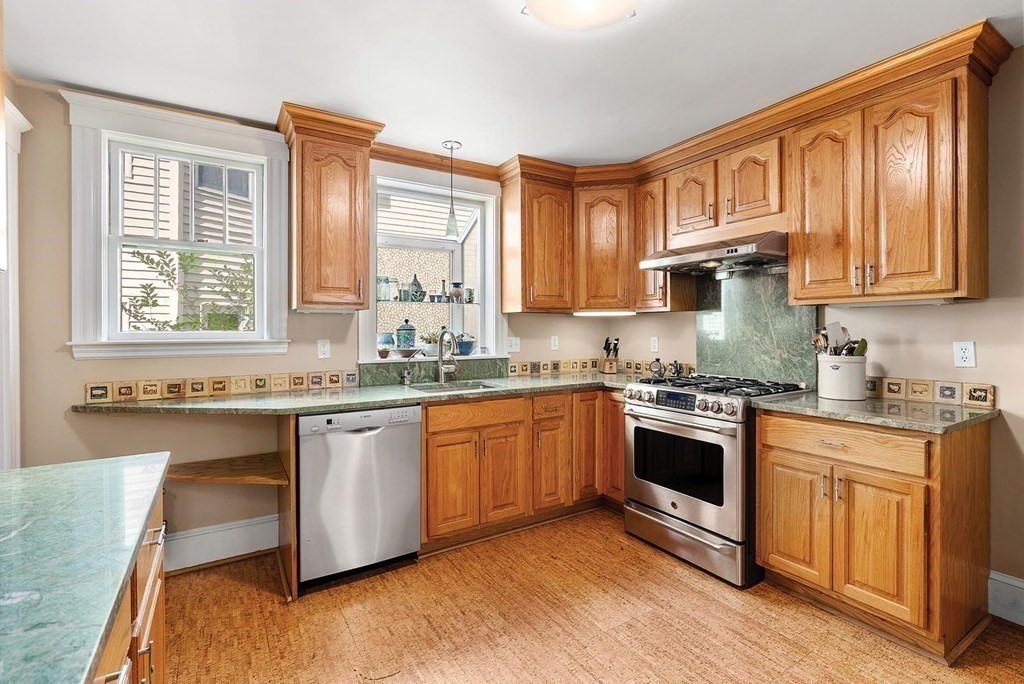209 Reservoir Road Brookline, MA 02467 - Photo 7 of 24 a kitchen with stainless steel appliances granite countertop a stove a sink and a granite counter tops with wooden floors
