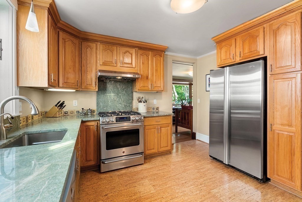 209 Reservoir Road Brookline, MA 02467 - Photo 8 of 24 a kitchen with stainless steel appliances granite countertop a stove a sink and a refrigerator