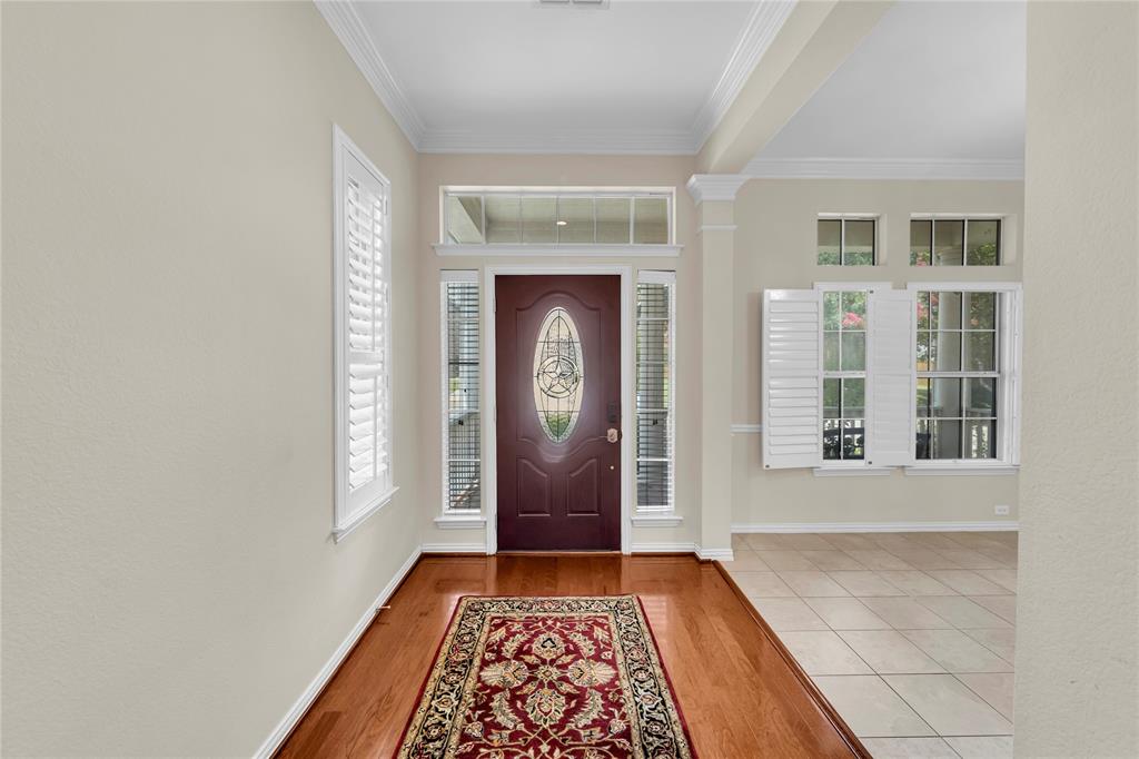 3920 Autumn Lane Bedford, TX 76021 - Photo 4 of 36 Entryway featuring a decorative mahogany front door with an oval glass insert and sidelights