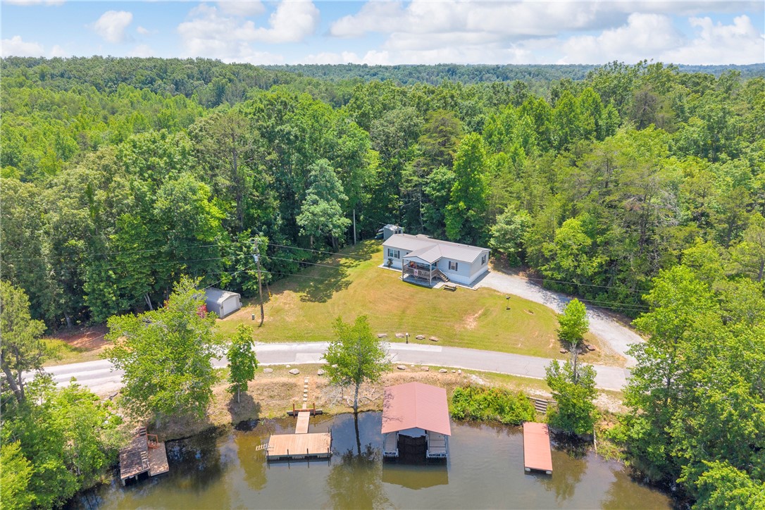 334 Lake Becky Road Mountain Rest, SC 29664 - Photo 3 of 46 A tranquil lakeside retreat with a private boat dock and wooded surroundings.