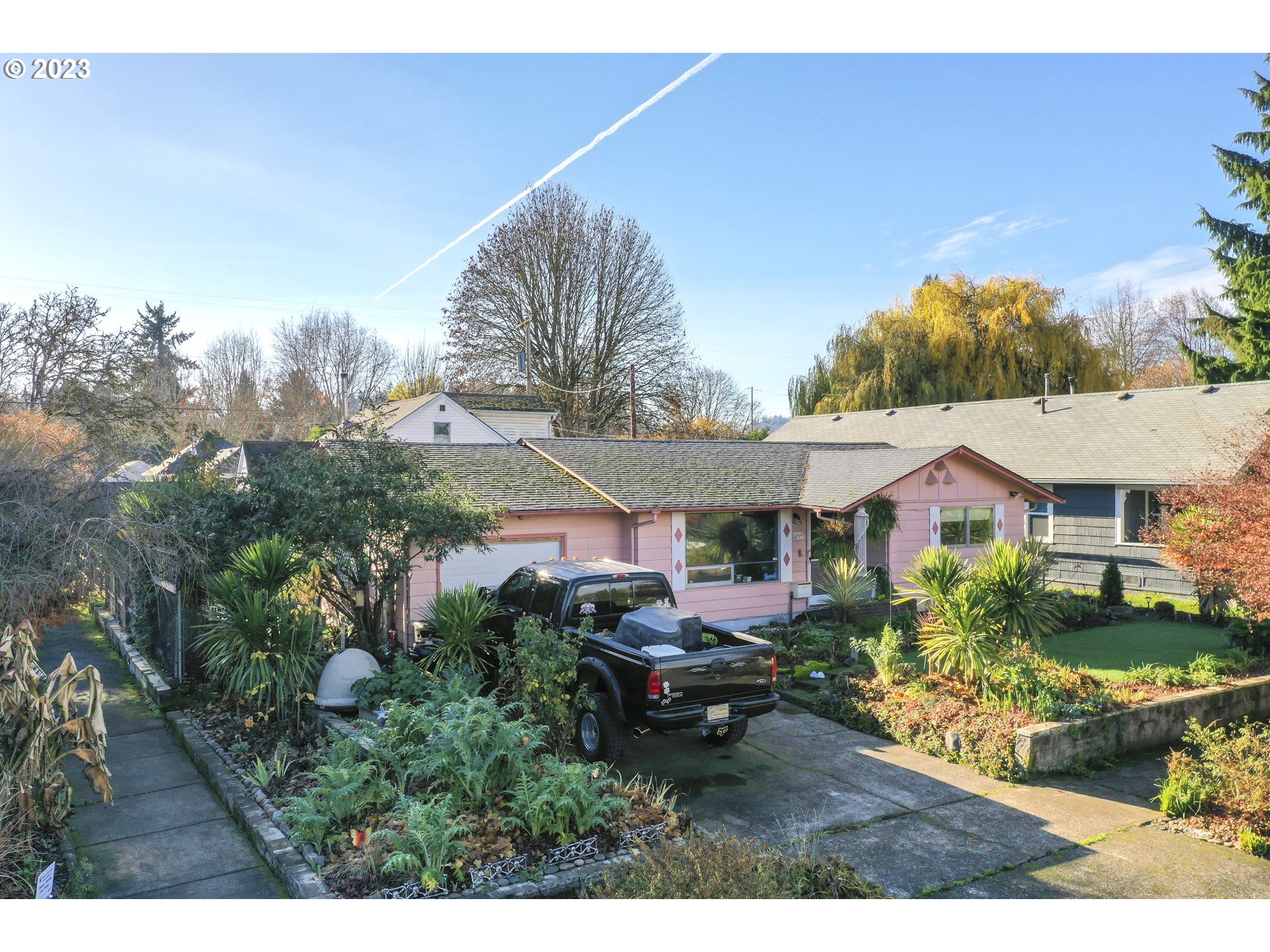 a view of house with outdoor space and garden