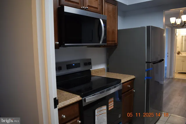 a kitchen with a stove and a refrigerator