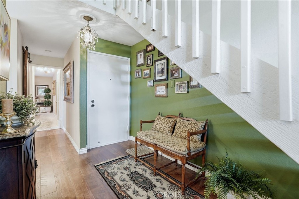 7890 East Spring Street, Unit 2L Long Beach, CA 90815 - Photo 4 of 47 a view of hallway with wooden floor and stairs