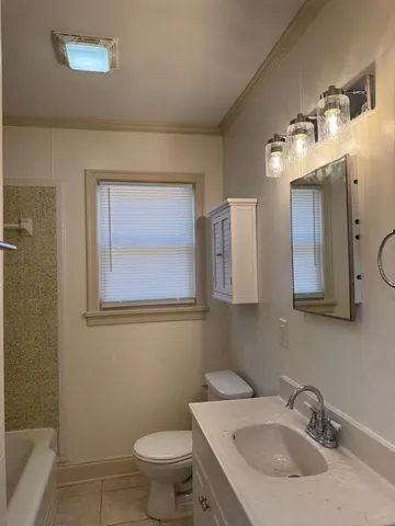 a bathroom with a sink toilet and mirror