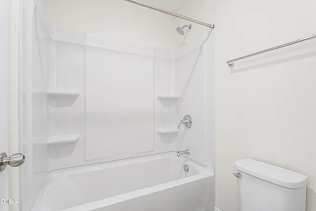 a bathroom with a bathtub and a toilet