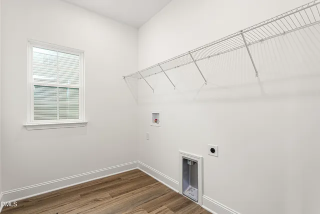a view of a room with wooden floor and white walls
