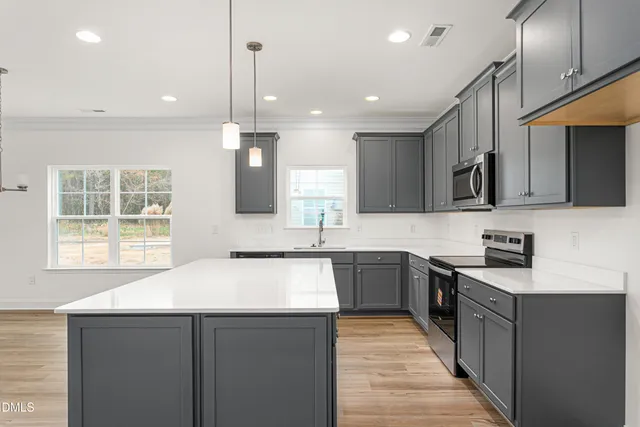 a kitchen with stainless steel appliances a sink stove and cabinets