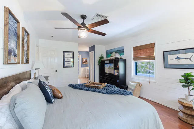 a kitchen with a kitchen island a stove and a wooden floors