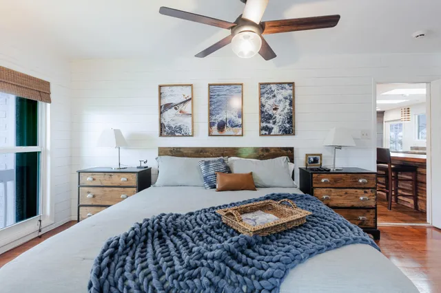 a bedroom with a large bed and a large window