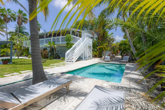 a large kitchen with a table and chairs