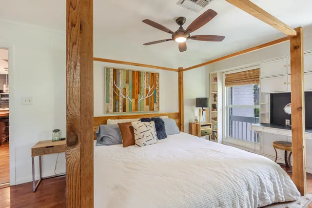 a view of a swimming pool with a lawn chairs under an umbrella