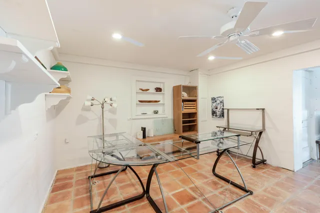a view of a porch with furniture and a yard