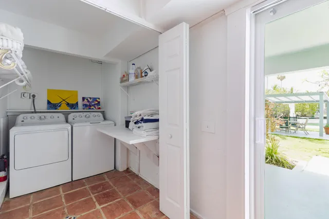 a view of swimming pool with lawn chairs and a yard