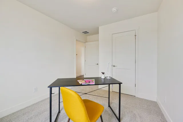 a view of a bedroom from a hallway