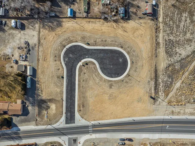 an aerial view of residential houses with outdoor space