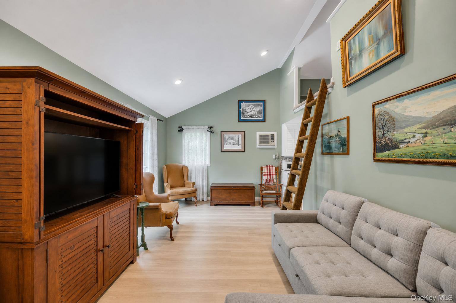19 Joan Road Bay Shore, NY 11706 - Photo 32 of 50 Vaulted ceilings defining a spacious living area with light wood-finish flooring