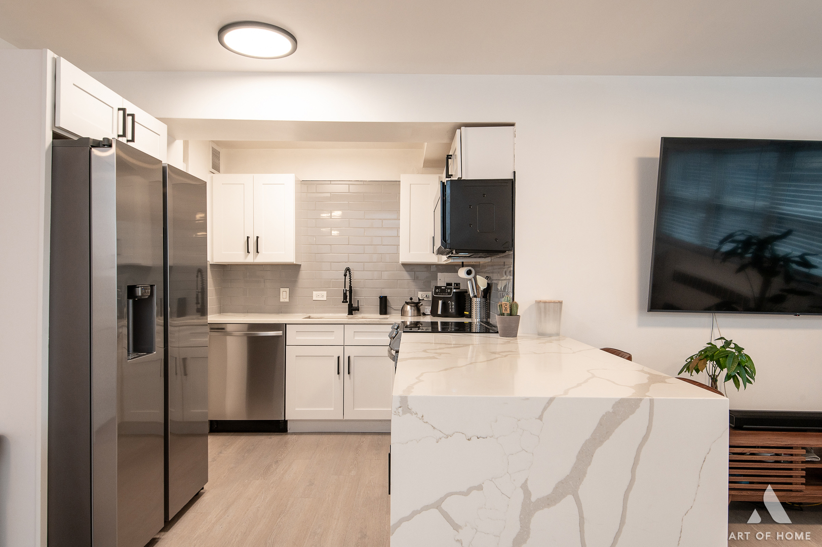 2909 North Sheridan Road, Unit 407 Chicago, IL 60657 - Photo 8 of 20 a kitchen with stainless steel appliances kitchen island granite countertop a refrigerator and a stove top oven