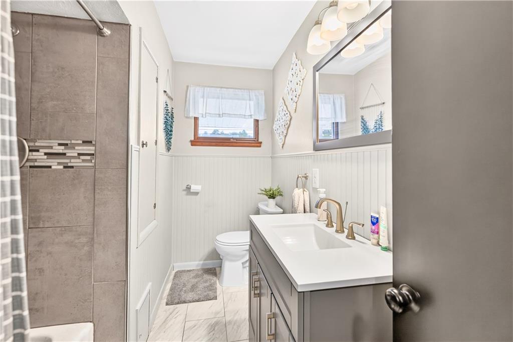1642 Rostraver Road Belle Vernon, PA 15012 - Photo 12 of 32 a bathroom with a sink vanity and a mirror