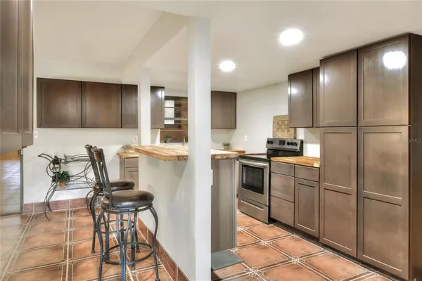 a kitchen with stainless steel appliances kitchen island granite countertop a sink and cabinets