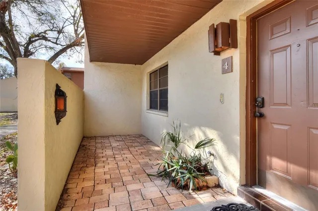 a backyard of a house with potted plants