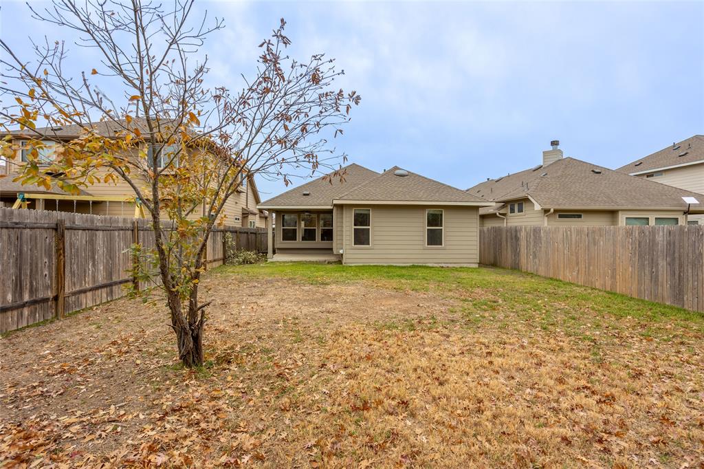 615 Stampede Road San Marcos, TX 78666 - Photo 26 of 26 A spacious backyard awaits, complete with a private patio area, perfect for outdoor living and entertaining.