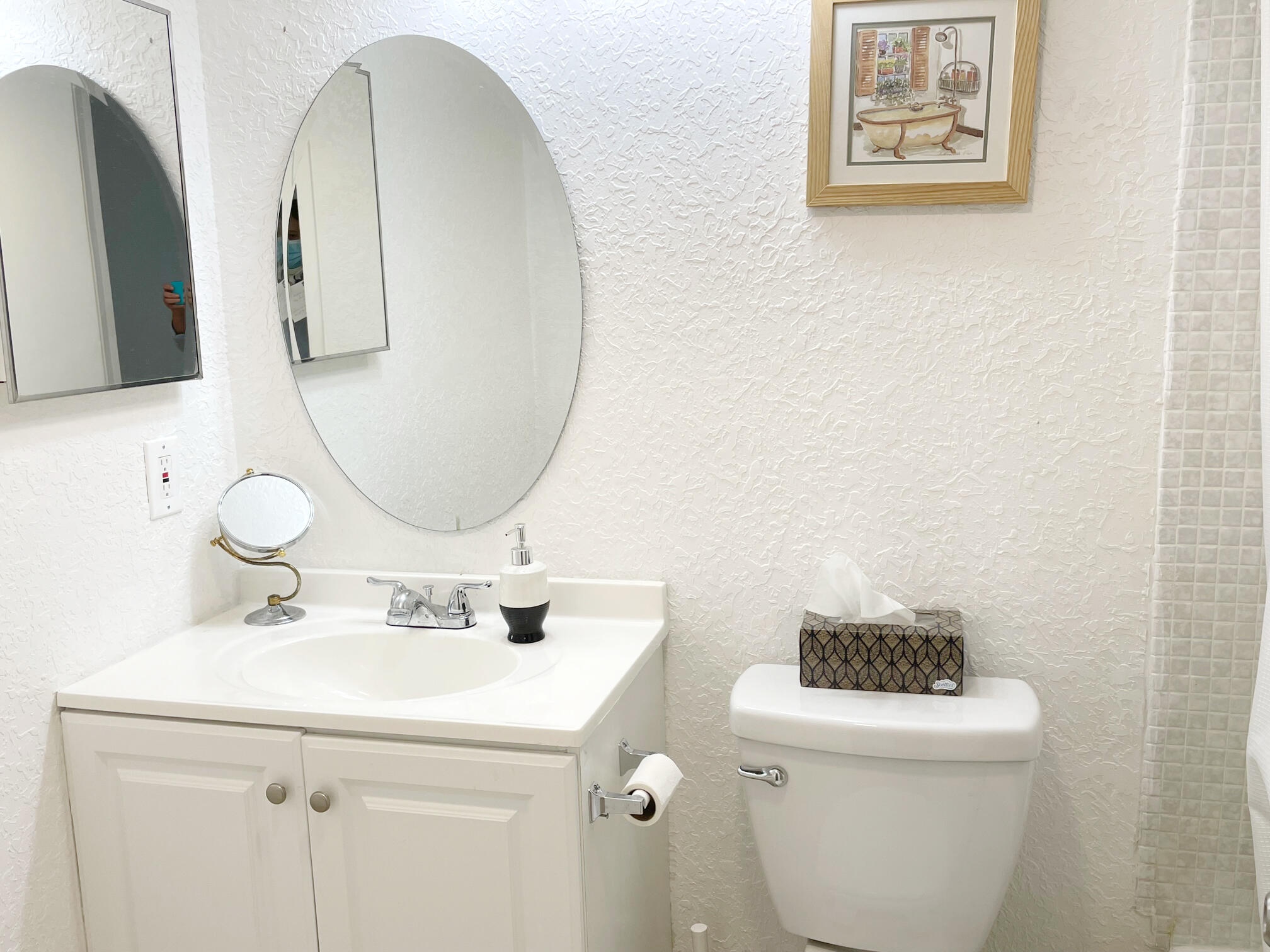 171 Suffolk F, Unit 171 Boca Raton, FL 33434 - Photo 16 of 21 a bathroom with a toilet sink and mirror