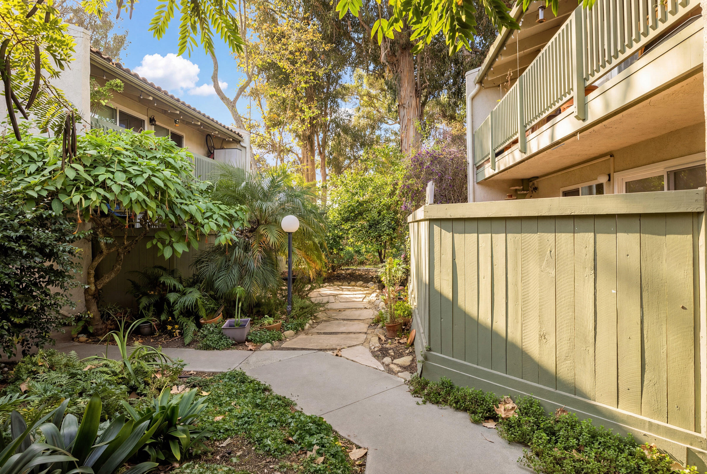 29 Dearborn Place, Unit 7 Goleta, CA 93117 - Photo 19 of 25 a view of a pathway of a building next to a yard