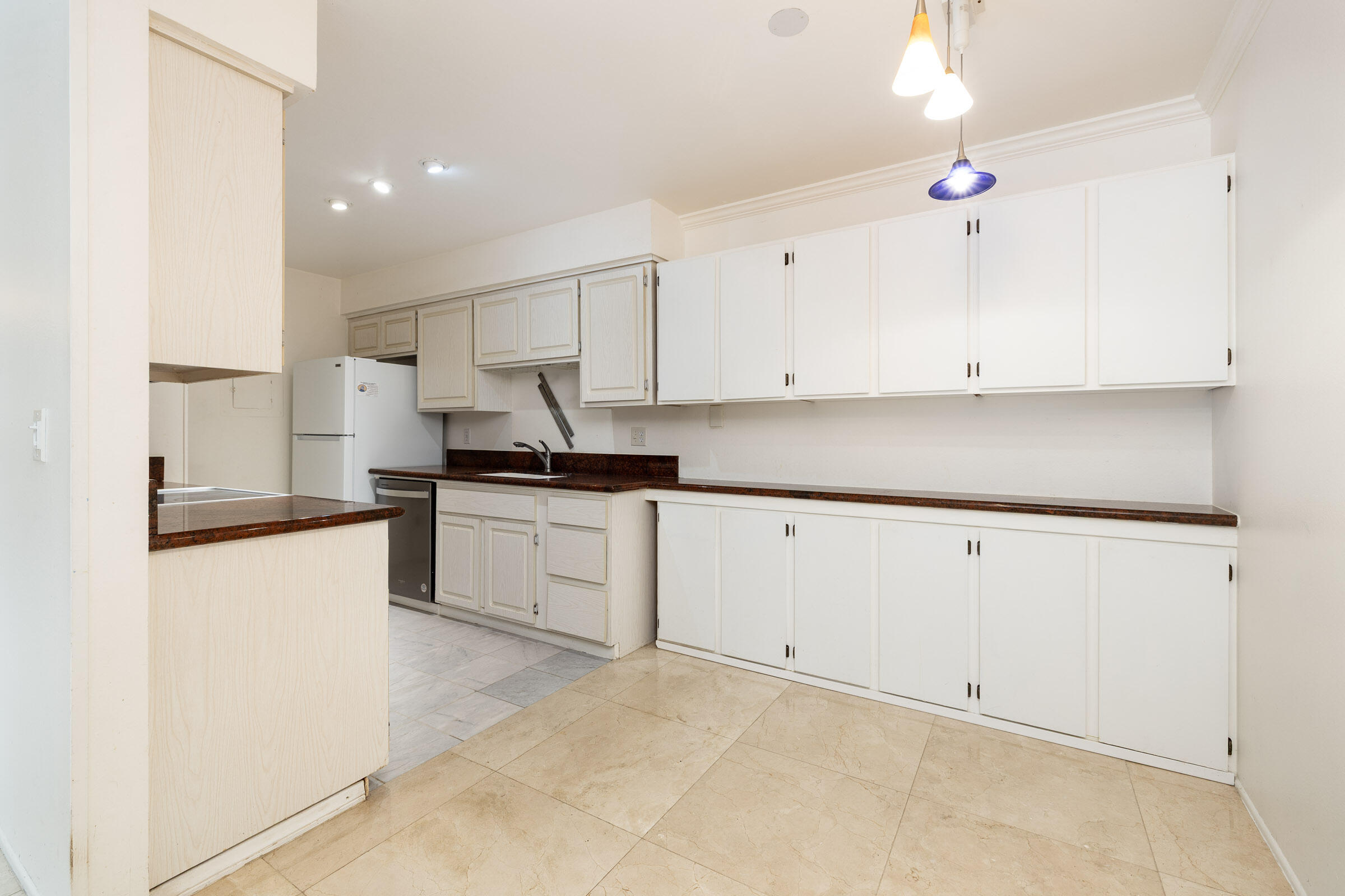 29 Dearborn Place, Unit 7 Goleta, CA 93117 - Photo 10 of 25 a kitchen with granite countertop white cabinets and white appliances