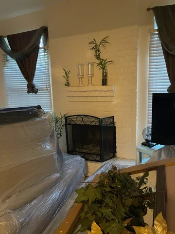 a bedroom with a bed and a television