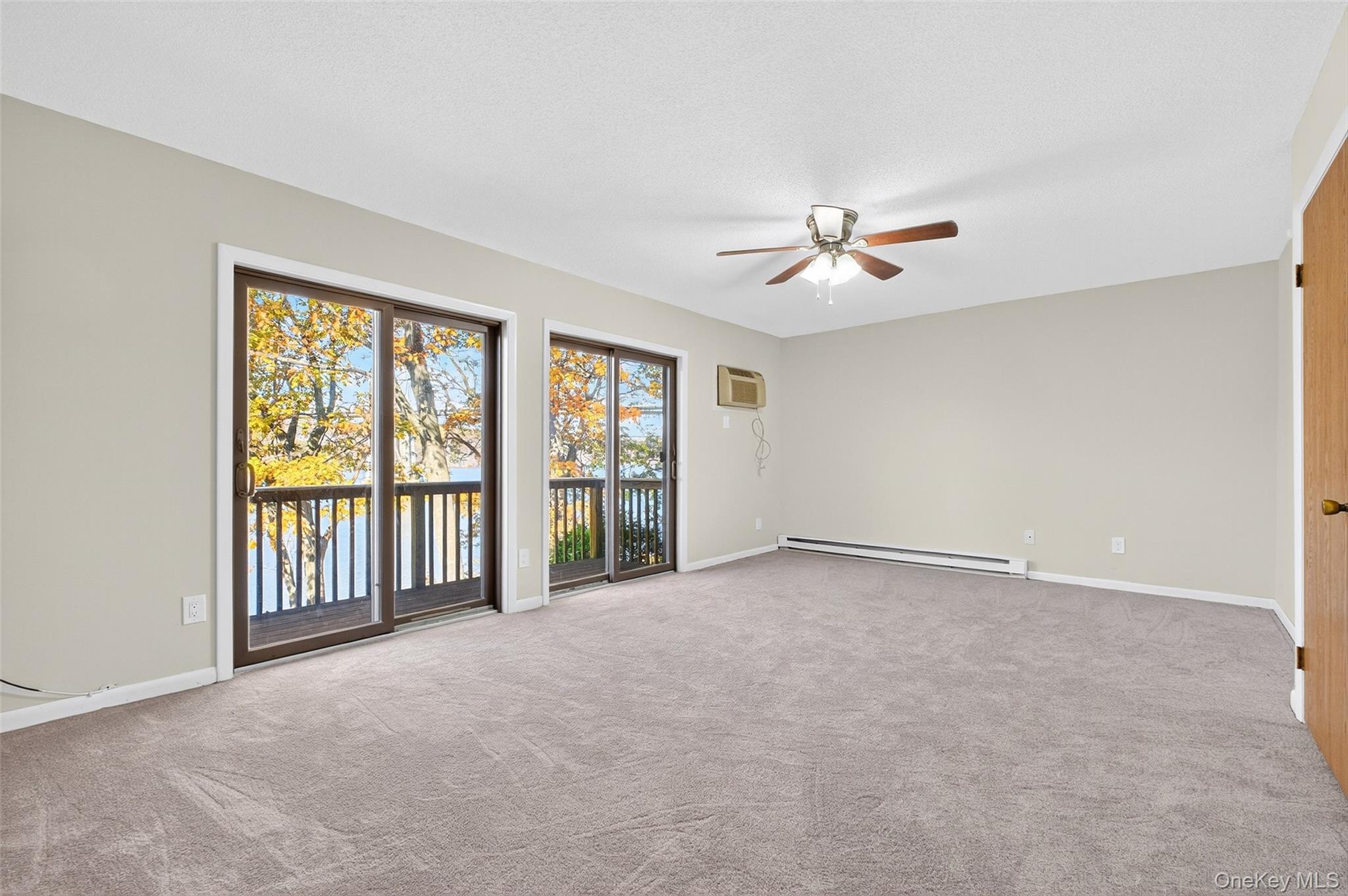 28 Hudson Heights Drive, Unit 28 Poughkeepsie, NY 12601 - Photo 25 of 50 an empty room with chandelier fan and windows