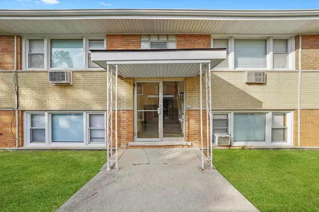 a view of a house with a large window and a yard