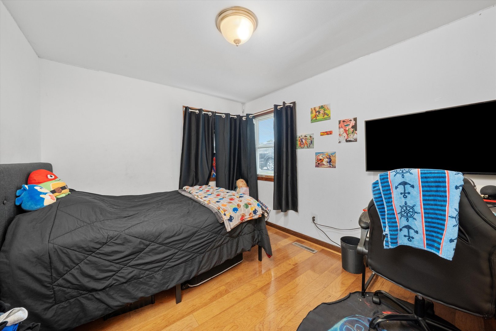 18508 Torrence Avenue Lansing, IL 60438 - Photo 23 of 39 a bedroom with a bed and a flat screen tv