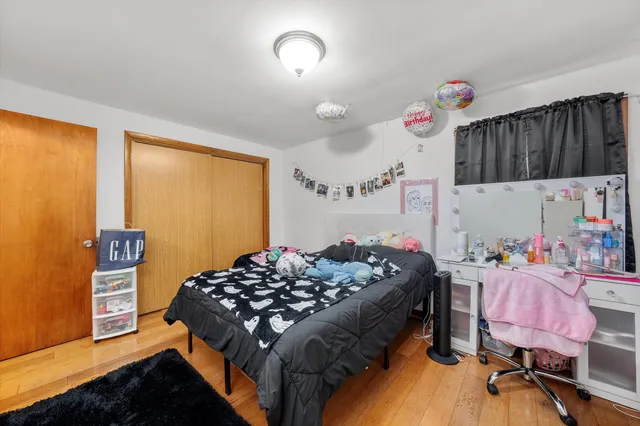 a bedroom with a bed dresser and a window