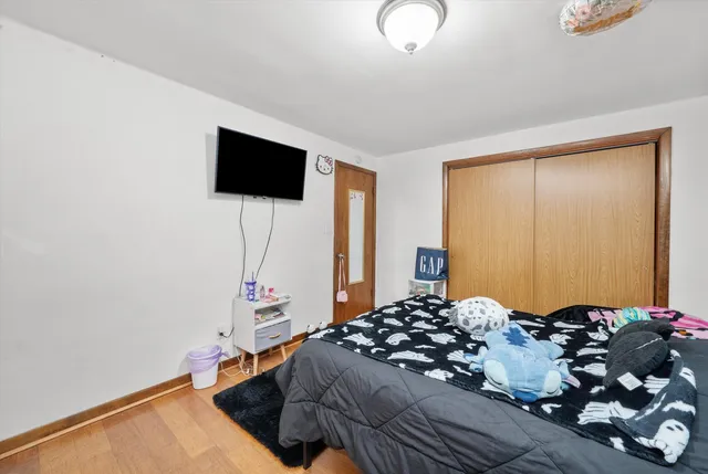 a bedroom with a bed and a flat screen tv