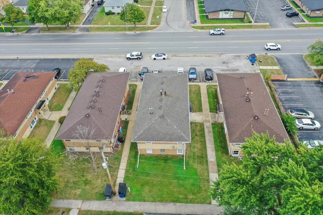 an aerial view of a house with a yard basket ball court