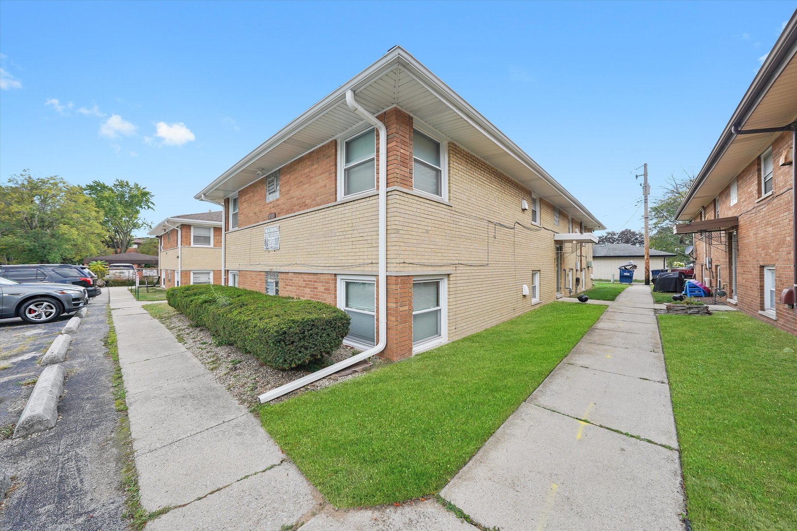 18508 Torrence Avenue Lansing, IL 60438 - Photo 37 of 39 a front view of a house with a yard and garage