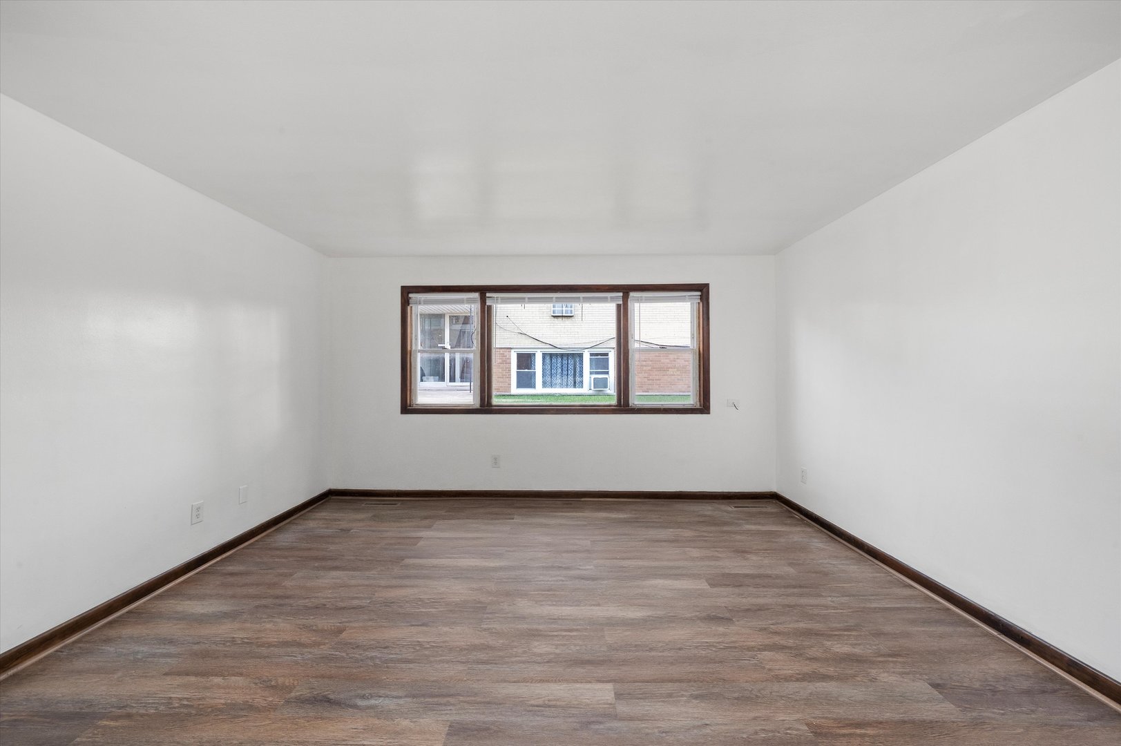 18508 Torrence Avenue Lansing, IL 60438 - Photo 4 of 39 an empty room with wooden floor and windows