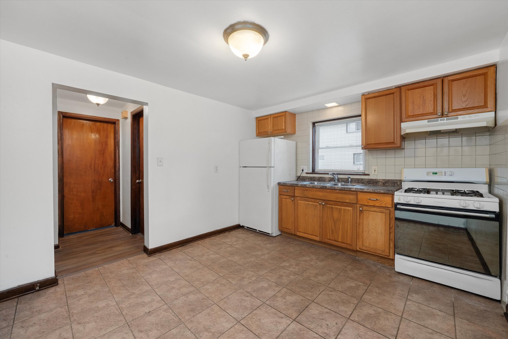 18508 Torrence Avenue Lansing, IL 60438 - Photo 7 of 39 a kitchen with granite countertop a stove top oven sink and cabinets