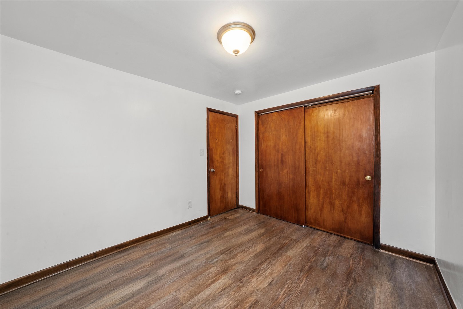 18508 Torrence Avenue Lansing, IL 60438 - Photo 10 of 39 an empty room with wooden floor and windows