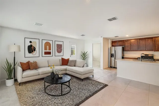 a living room with furniture kitchen view and a table