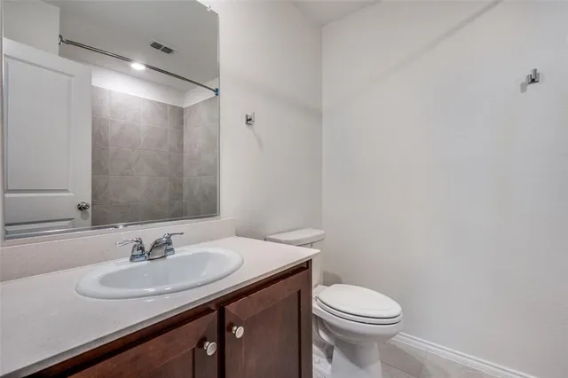 a bathroom with a sink toilet and a mirror