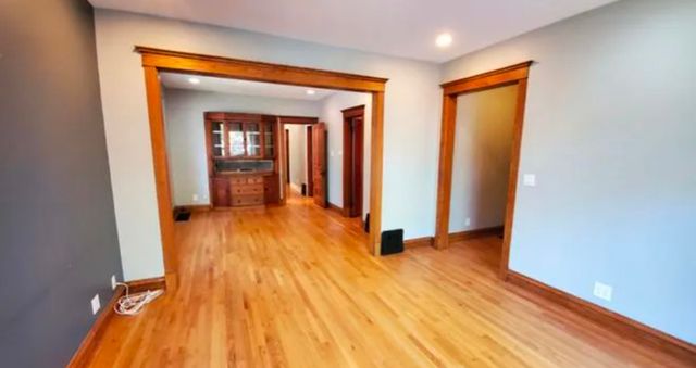 a view of a room with wooden floor and a bathroom