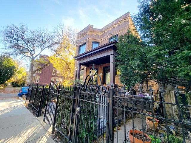 a view of a house with iron fence