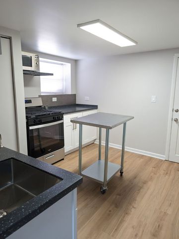 a kitchen that has a sink and a stove