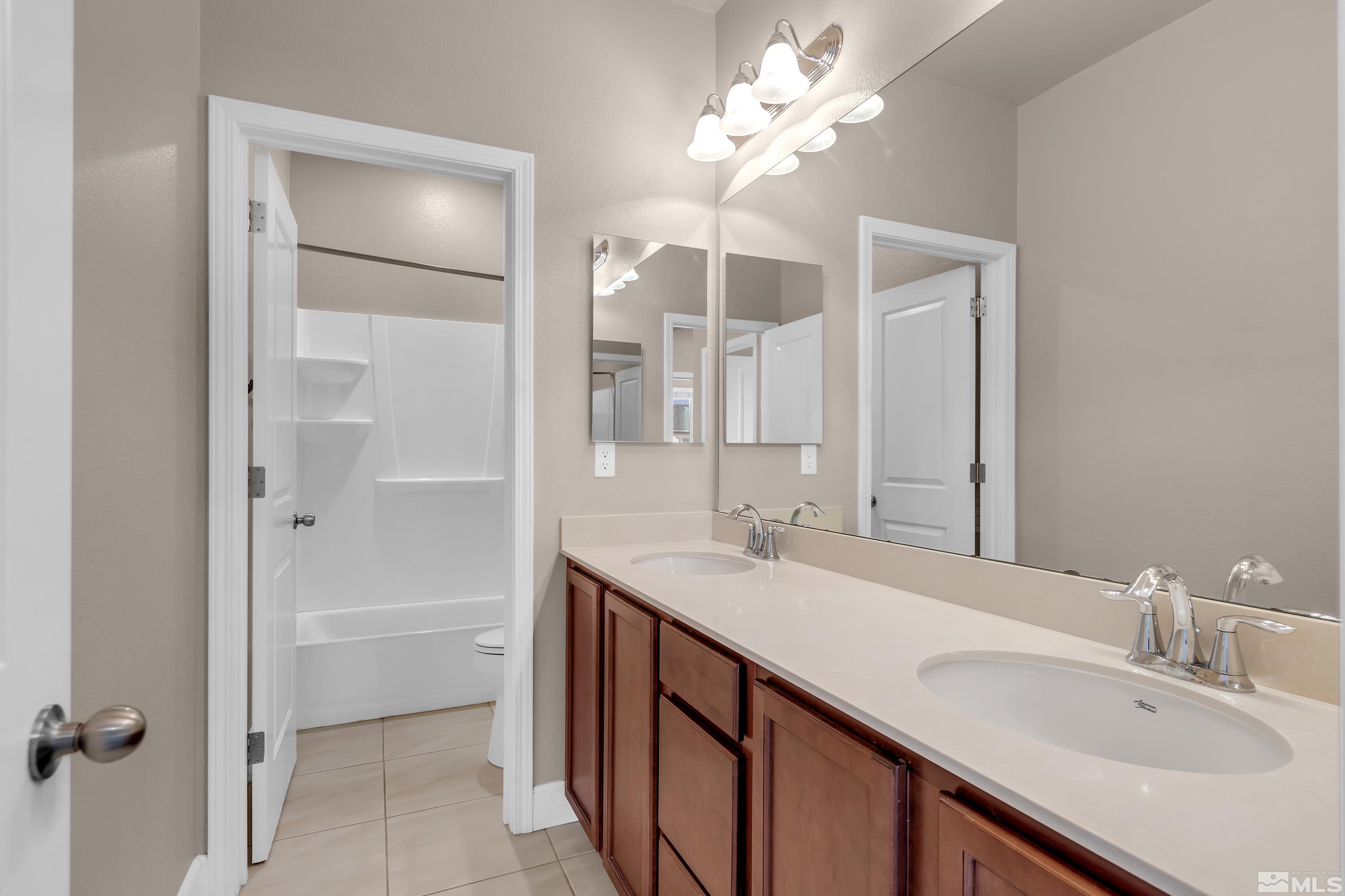 9352 Bay Drive Reno, NV 89506 - Photo 25 of 37 a bathroom with a sink double vanity and a mirror