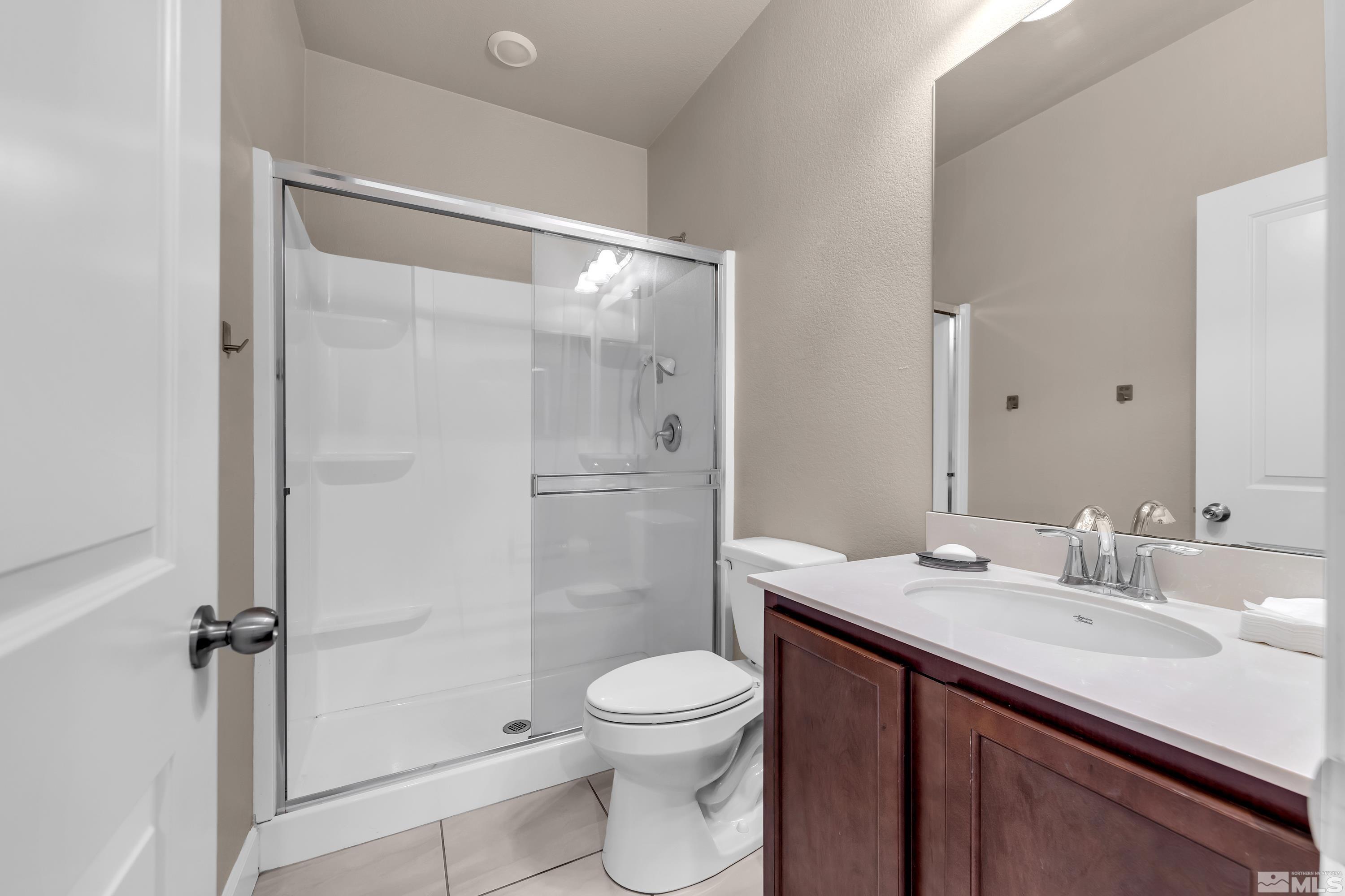 9352 Bay Drive Reno, NV 89506 - Photo 30 of 37 a bathroom with a sink a toilet and shower