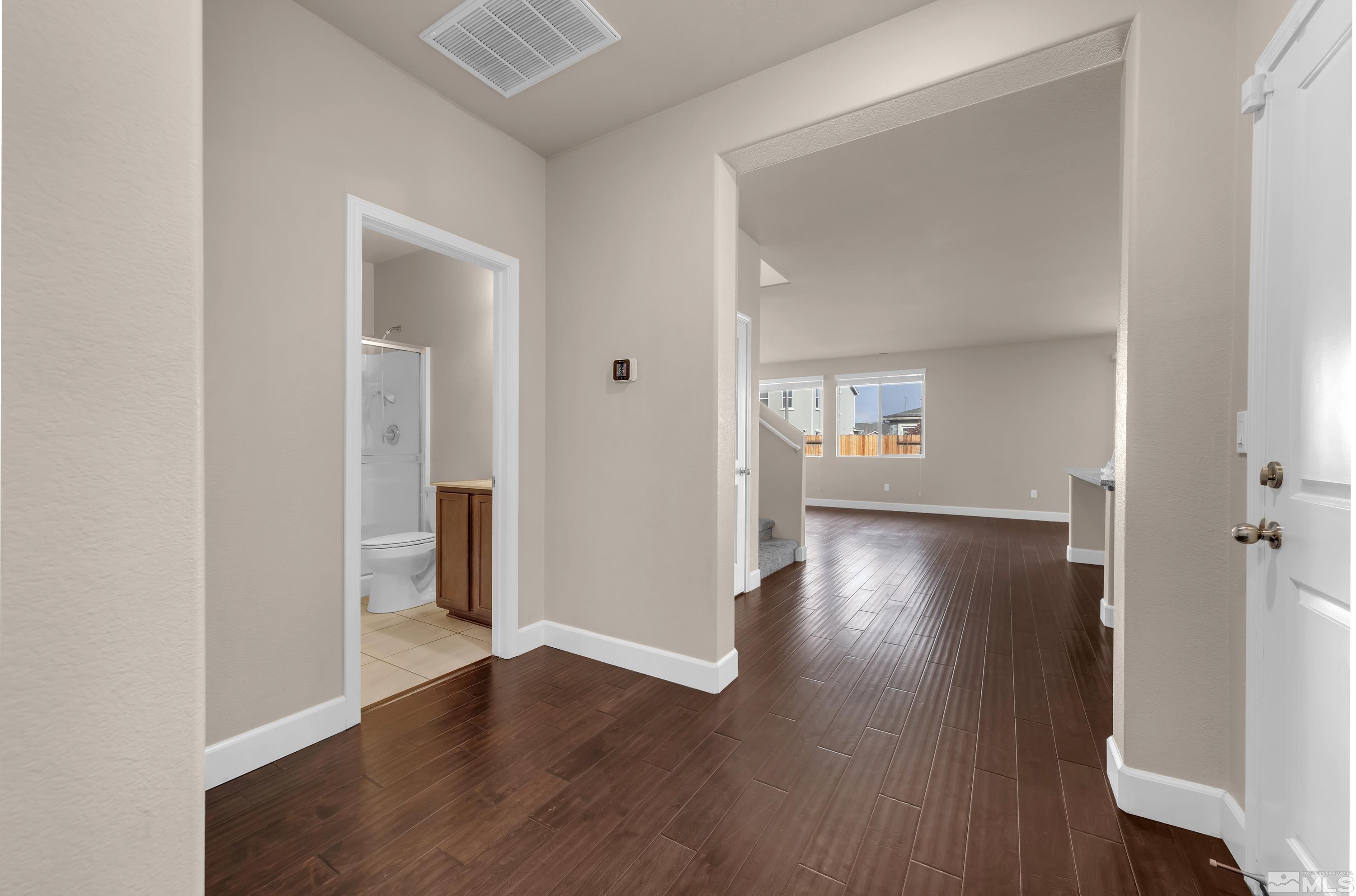 9352 Bay Drive Reno, NV 89506 - Photo 3 of 37 an empty room with wooden floor and windows