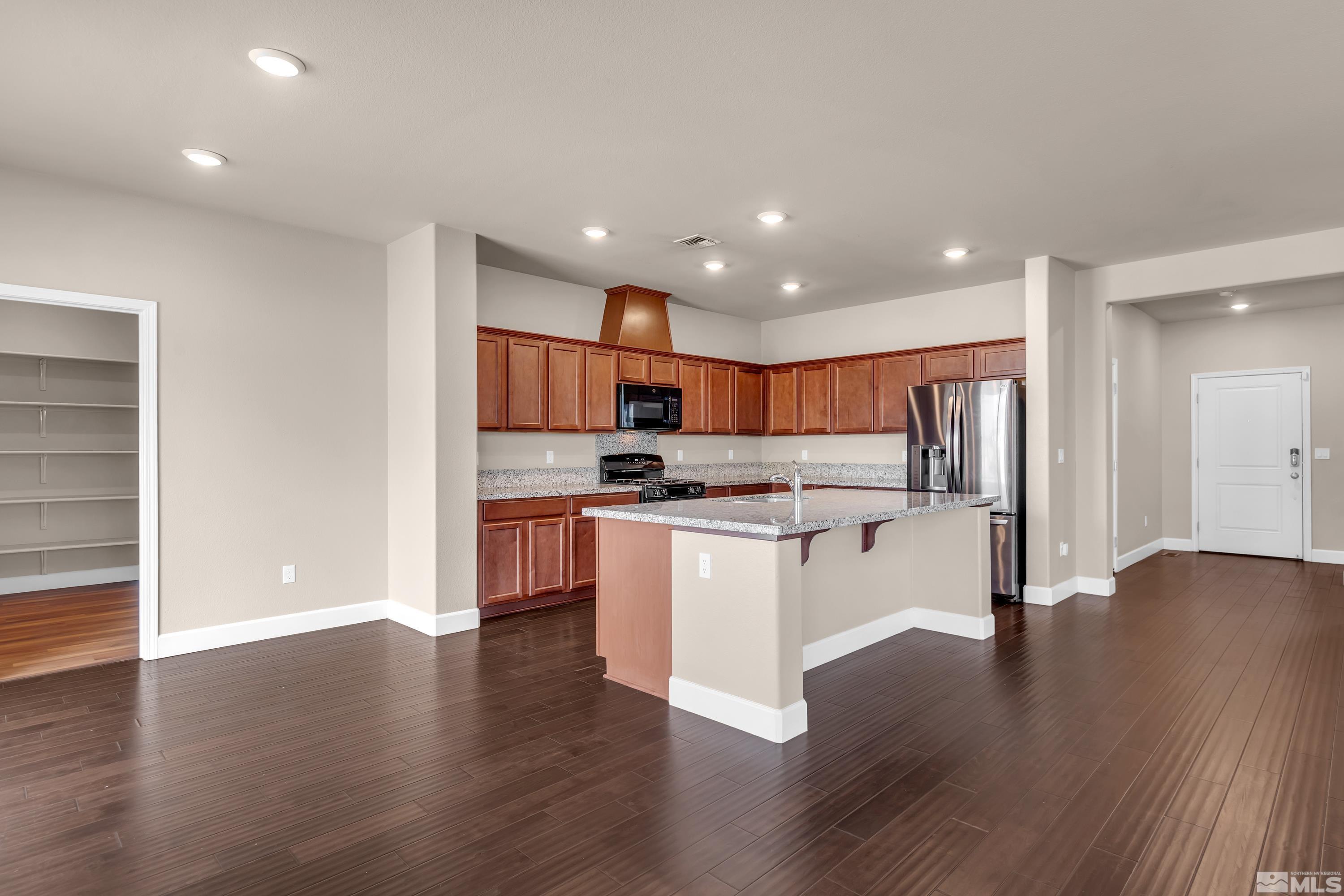 9352 Bay Drive Reno, NV 89506 - Photo 6 of 37 a kitchen with a refrigerator and a sink