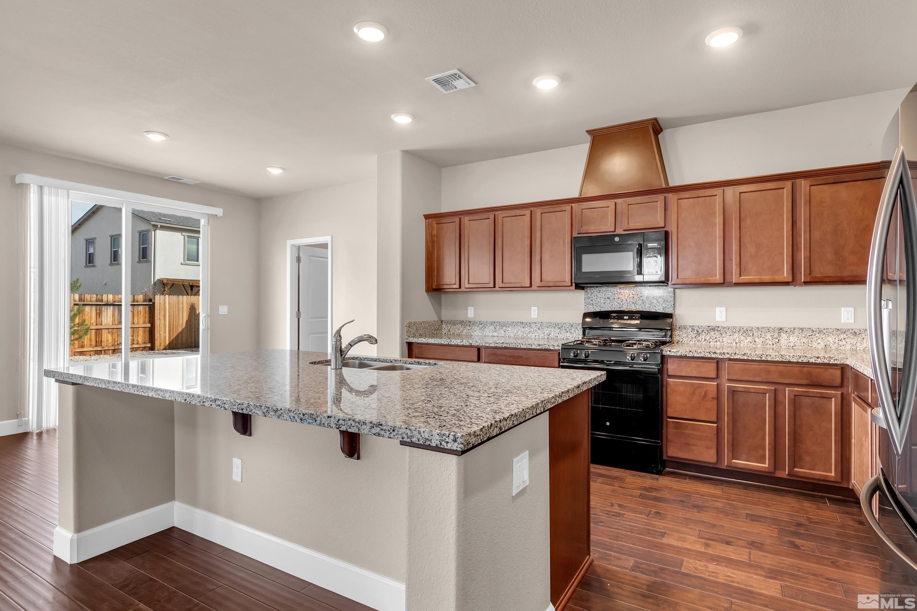 9352 Bay Drive Reno, NV 89506 - Photo 8 of 37 a kitchen with stainless steel appliances granite countertop a sink stove and refrigerator