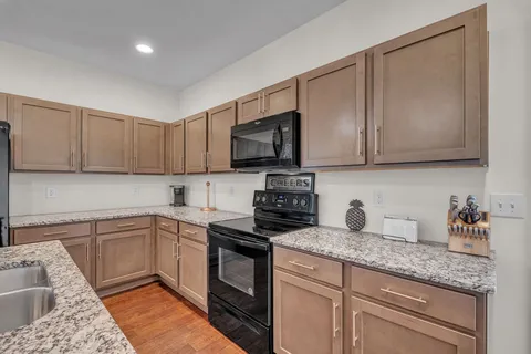 a kitchen with appliances cabinets and a counter top space